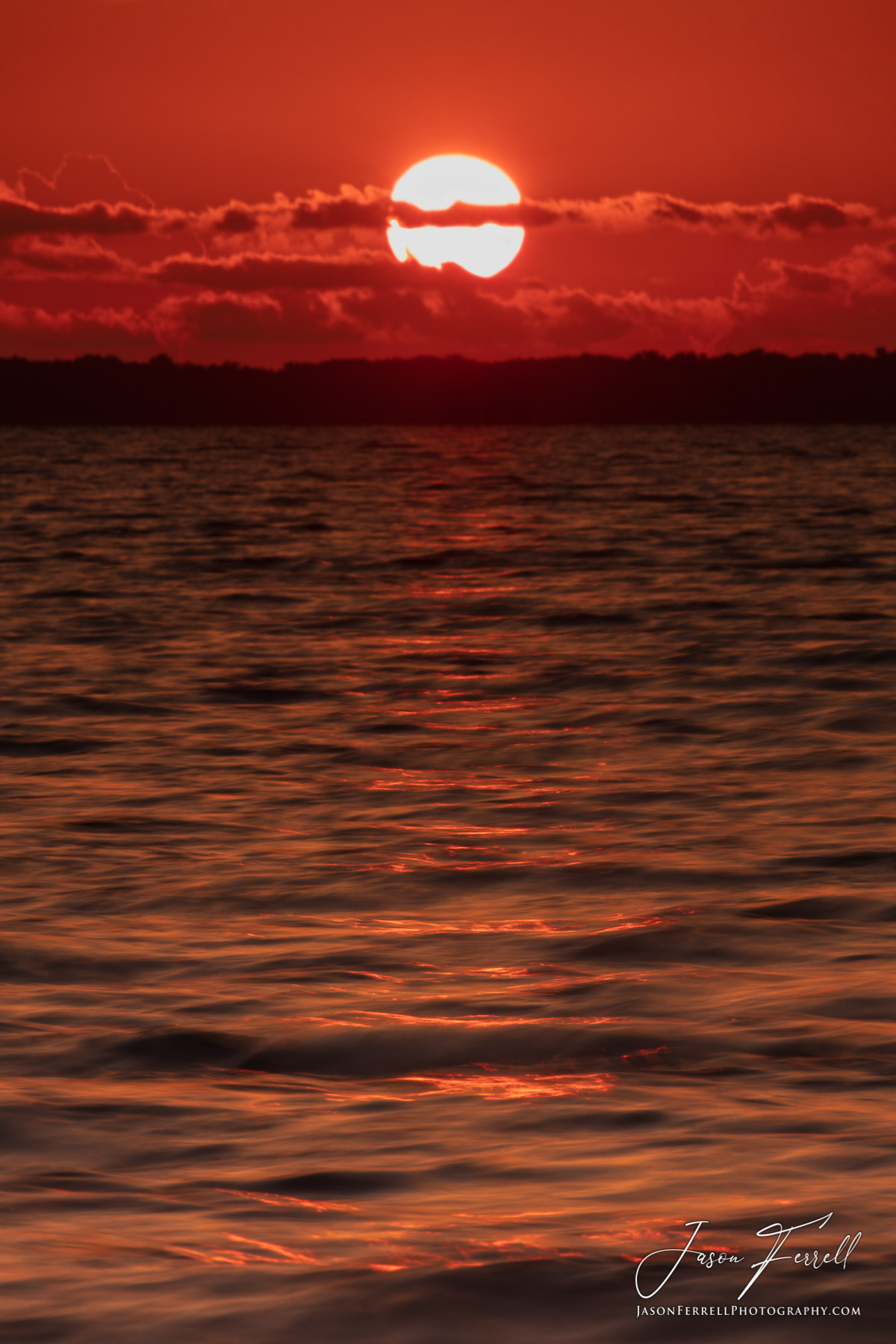 The sun casts it last rays of light before it tucks behind the clouds and below the horizon.