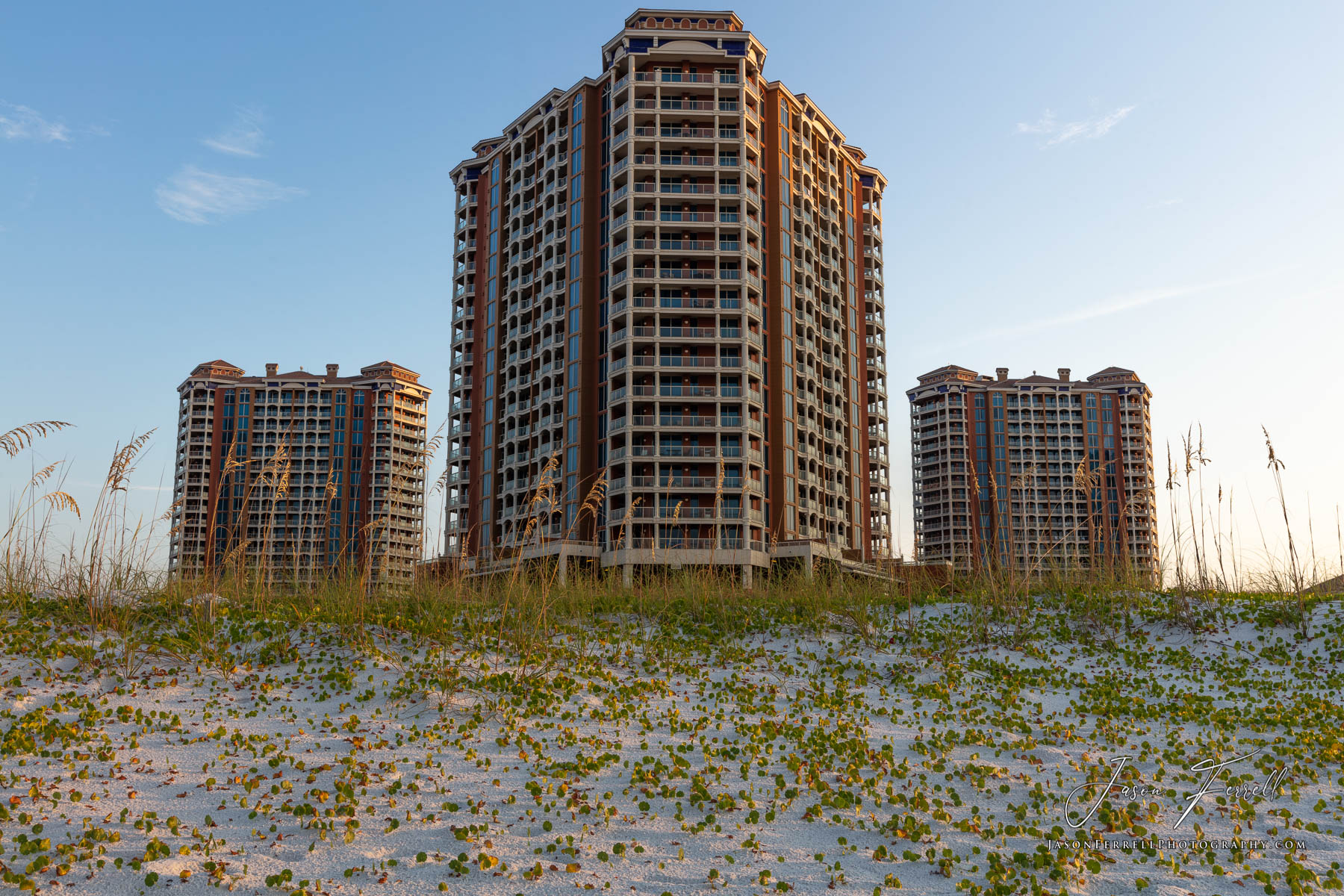 An early morning sunrise photo of the Portofino Island Resort Towers on the beach.