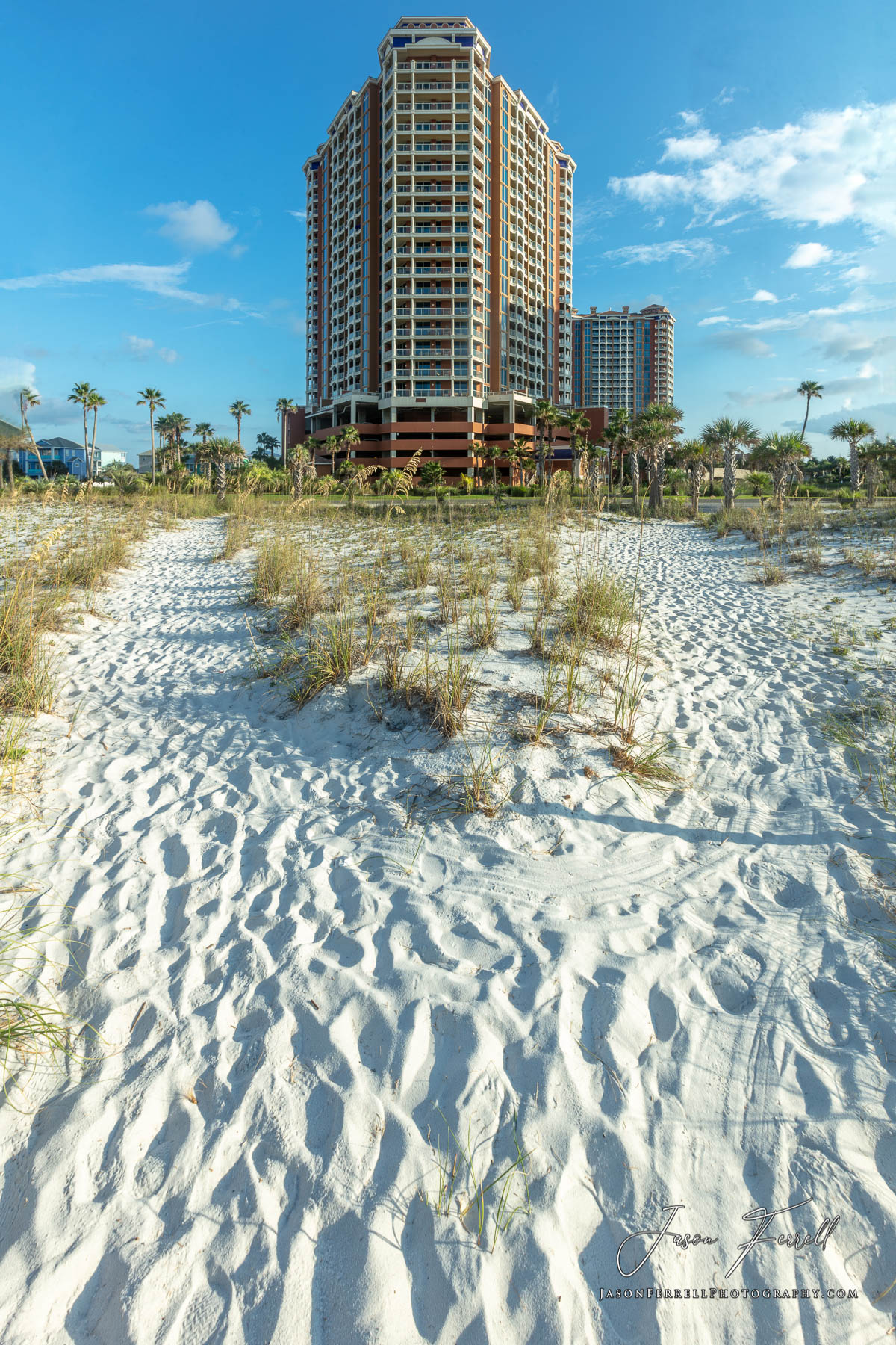An early morning sunrise photo of the Portofino Island Resort Towers on the beach.