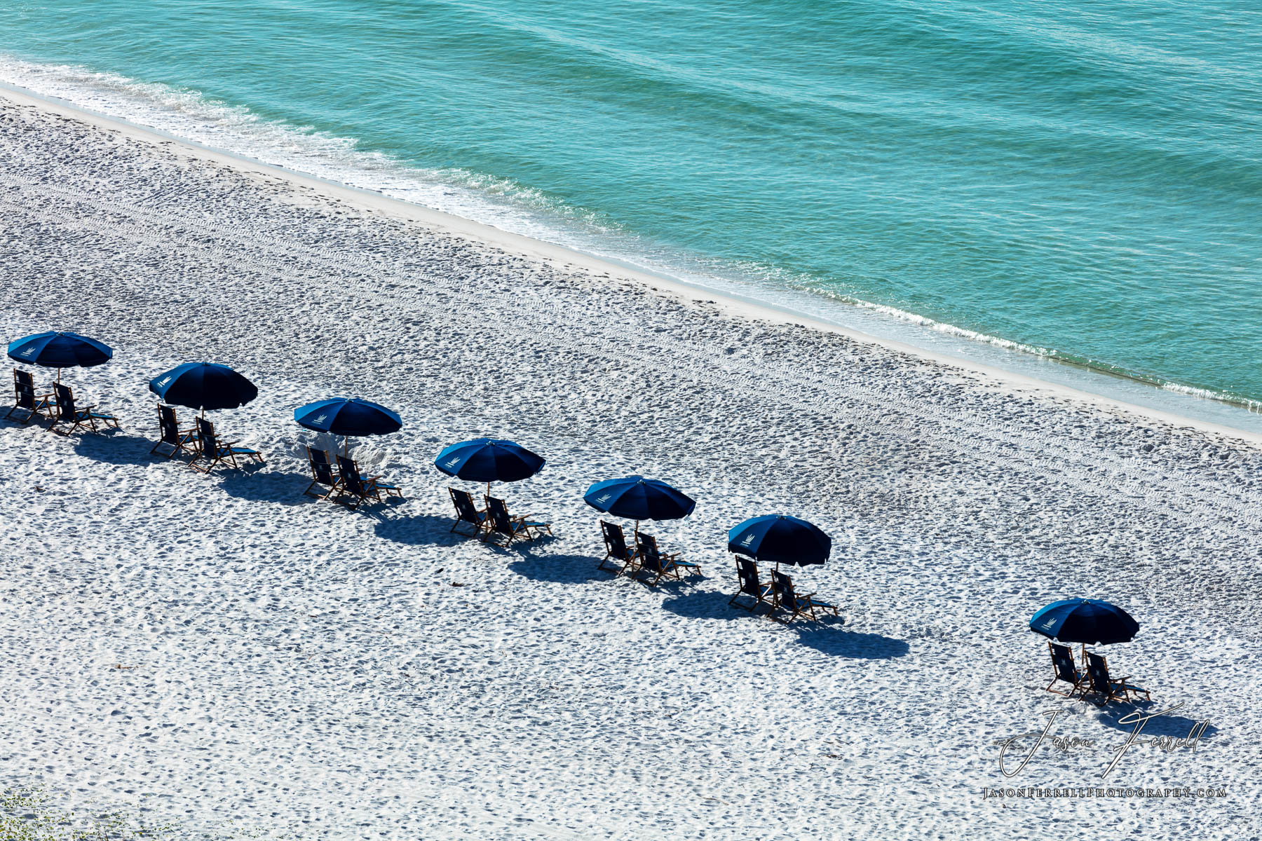 A row of beach lounge chairs from the Portofino Island Resort.