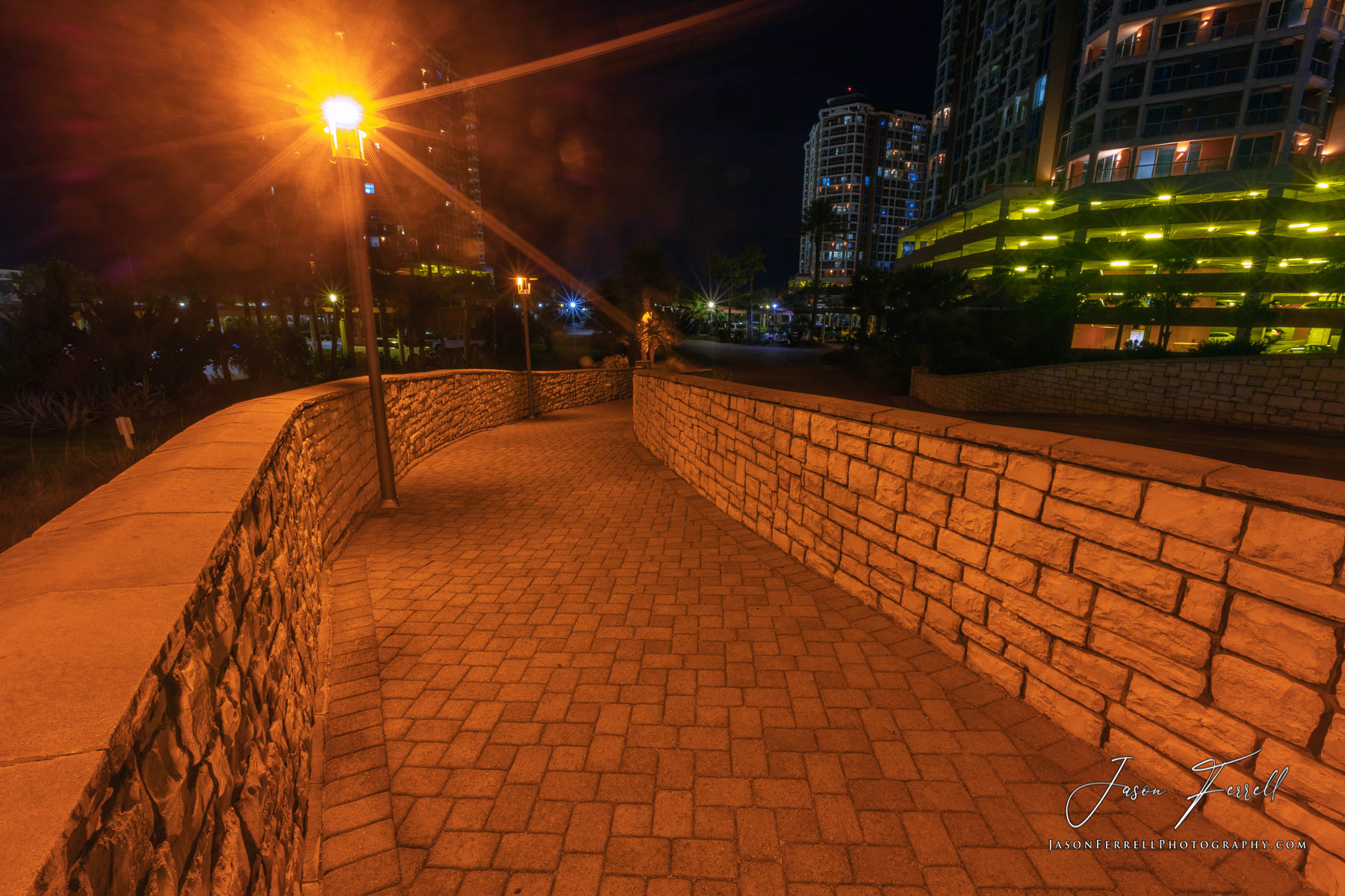 A nighttime photo of the Portofino Island Resort with street lamps illuminating the sidewalk.